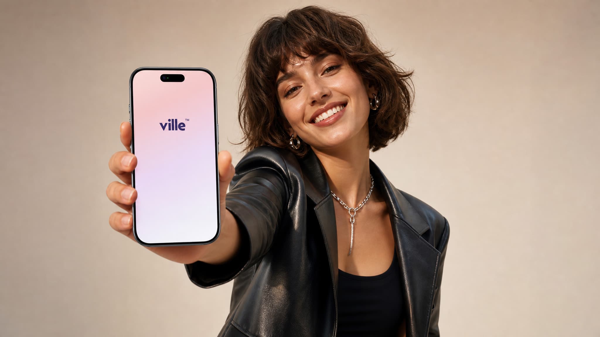 Person holding an iPhone showing the ville app