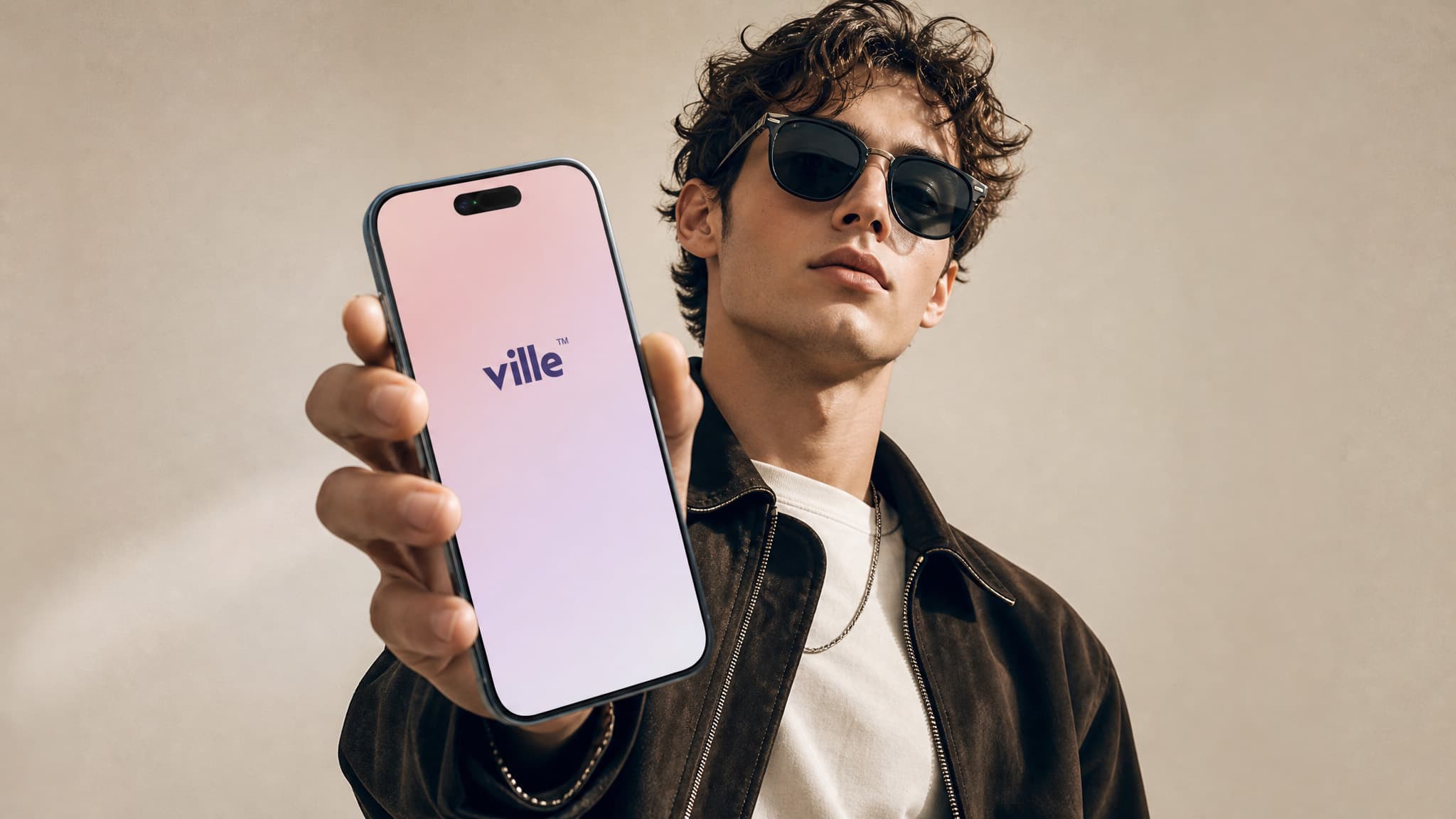 Person holding an iPhone showing the ville app